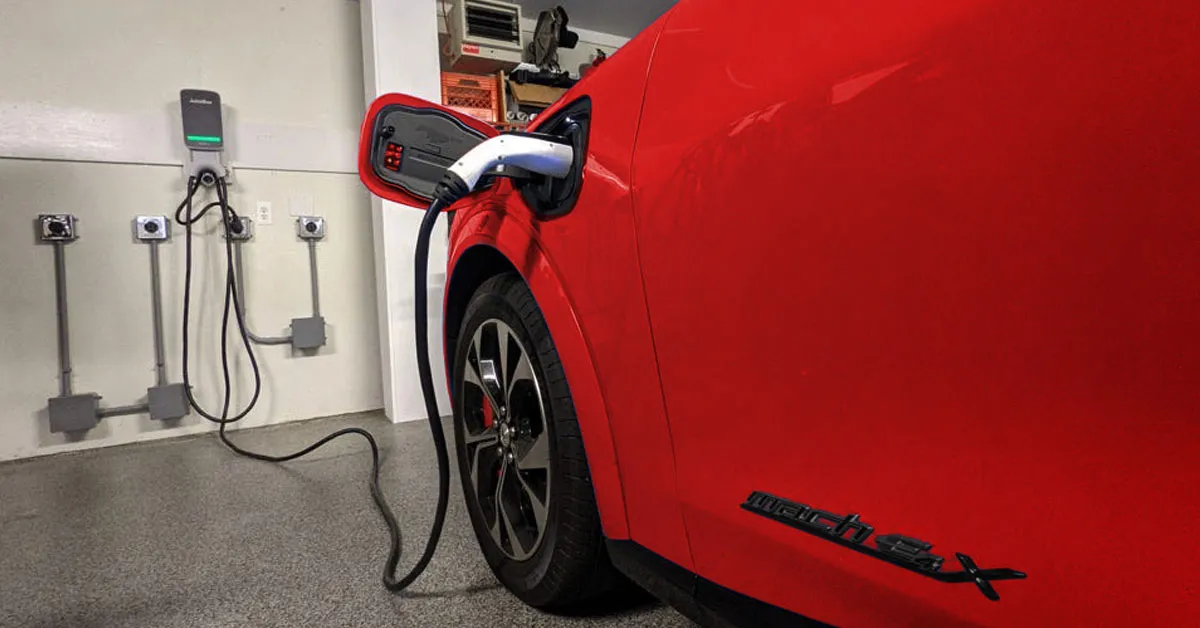 red car charging in a garage